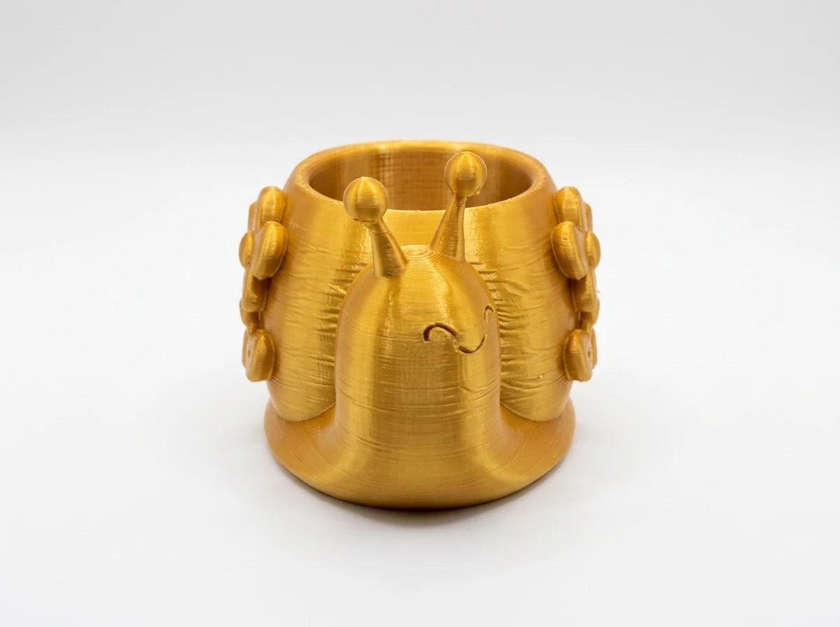 Gold 3D printed crown-shaped cup holder on white surface